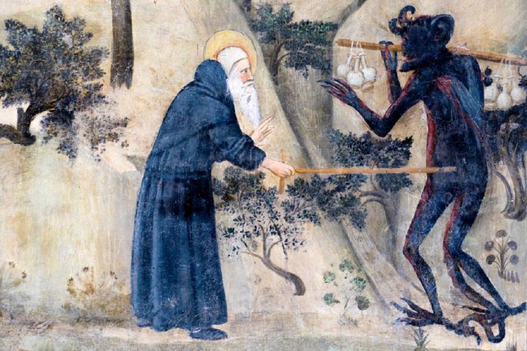 The holy hermit drives away the demon (medieval Christian fresco)
