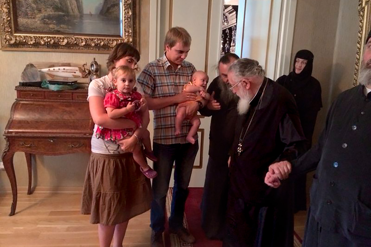 Kirill and Ana with the first child and patriarch
