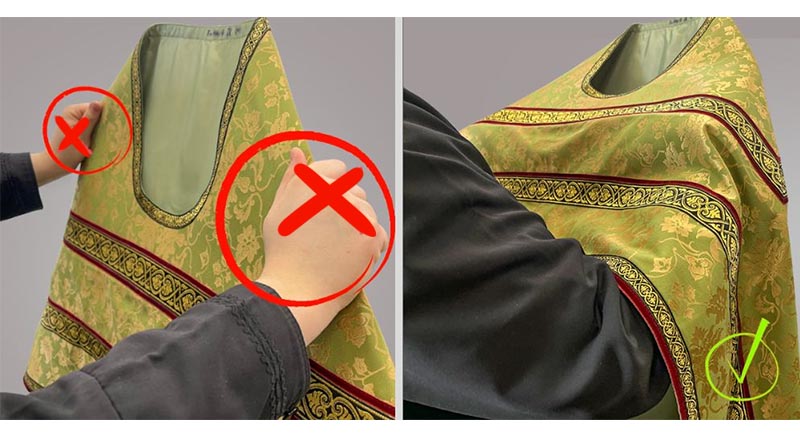 Try to take the phelonion “under the shoulders”, but not “by the shoulders”