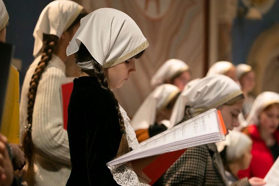 A member of Children choir studying music sheets before the service