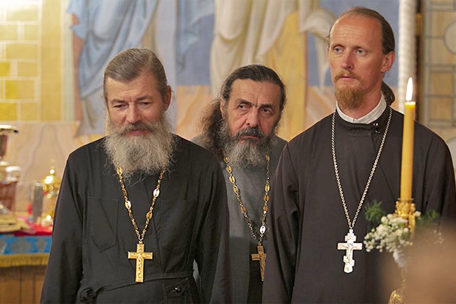 Father Rodion (right) wears a shirt under his undercassock.