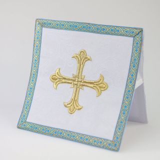 white burse with an embroidered gold cross