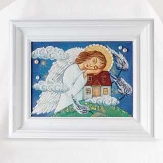 the framed picture of the angel hugging the house in the storm