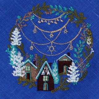 blue linen table napkin with embroidered Christmas market with trees
