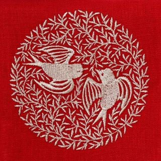 red table napkin with embroidered doves