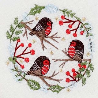white table napkin with embroidered bullfinches