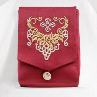 red case with embroidered grapes and a button
