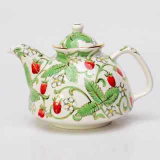 handmade nice summer teapot with berries flowers leaves