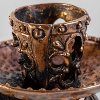 bronze candle holder with three legs