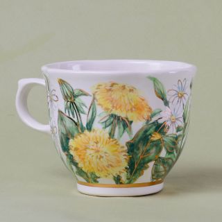 handmade ceramic tea cup and saucer with dandelions and chamomiles