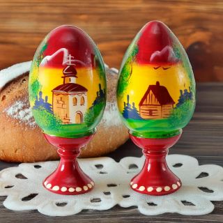wooden hand-painted egg with a stand and church painting