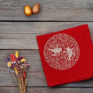 red table napkin with embroidered doves