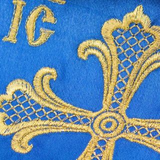 blue bookmark for the holy gospel with a golden embroidery and fringe