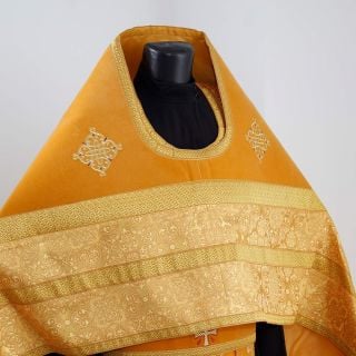 yellow velvet and silk priest vestment with embroidered patterns and saints