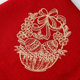 Red paschal with a basket filled with eggs and flowers