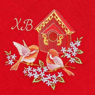 red paschal table napkin with embroidered birds