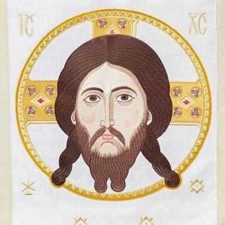 white analogion cover with medallion of Christ and tassels