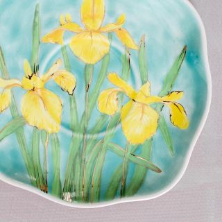 yellow irises in blue ceramic tea set and a saucer set