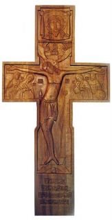 handcarved cross with Jesus and prayer
