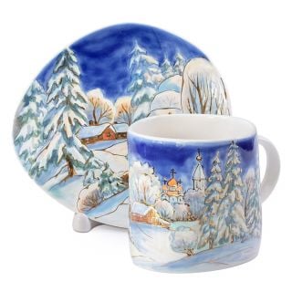 cup and saucer with painted winter scenery