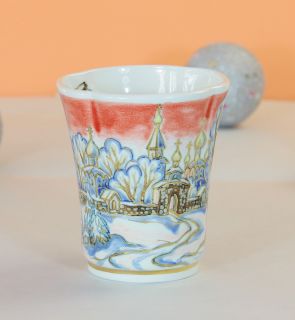 ceramic cup and a saucer set with red sky in winter landscape
