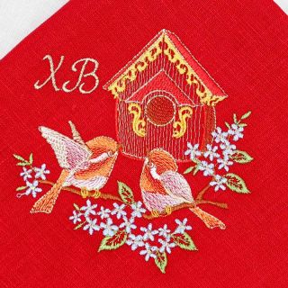 red paschal table napkin with embroidered birds