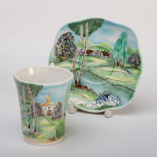 ceramic cup and a saucer set hand-painted and decorated with gold elements