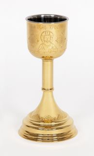 gilded chalice with engraved icons of Jesus and crosses