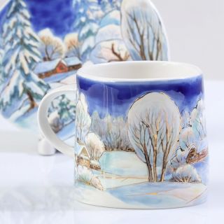 cup and saucer with painted winter scenery