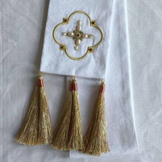 white bookmark with embroidered cross and decorated with pearls and tassels