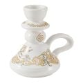 white ceramic candleholder with patterns