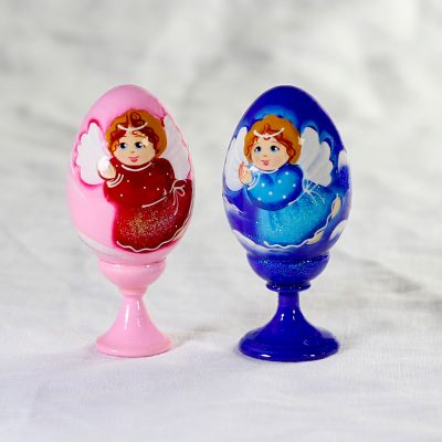 blue and pink eggs on a stand with angel
