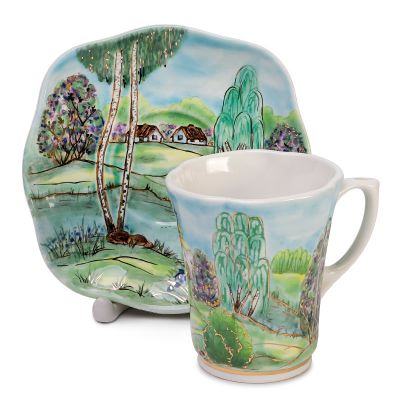 ceramic cup and a saucer set hand-painted and decorated with gold elements