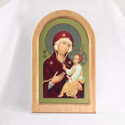 wooden icon with printed the Mother of God on golden background