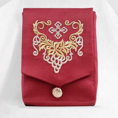 red case with embroidered grapes and a button