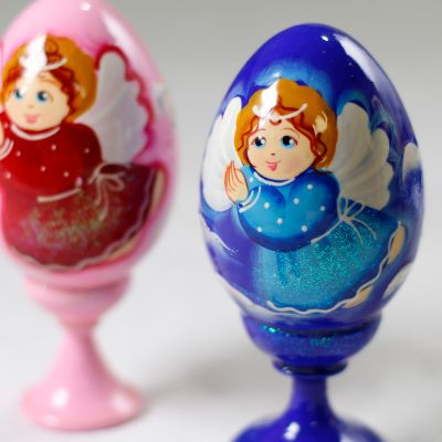 blue and pink eggs on a stand with angel