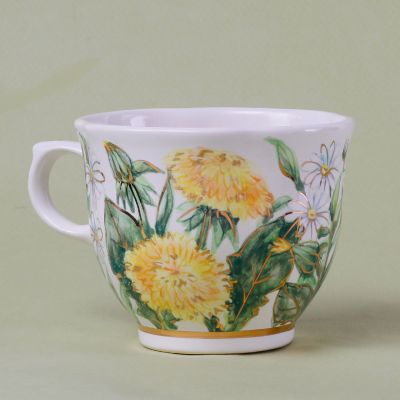 handmade ceramic tea cup and saucer with dandelions and chamomiles
