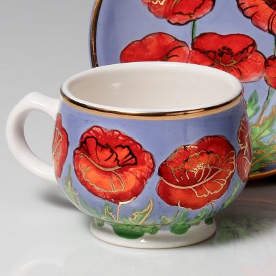 hand-painted cup and saucer set with red poppies and gold elements