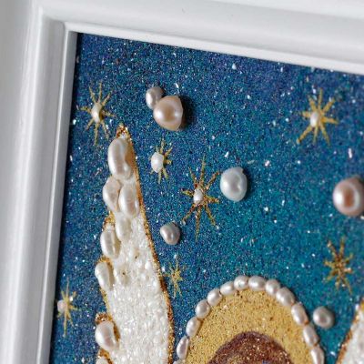 ground semi-precious stone picture of an angel with a star