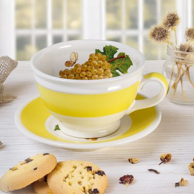 ceramic cup and saucer set with yellow live and grapes and butterfly