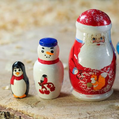 Christmas blue nesting tree doll with painted penguins and balls