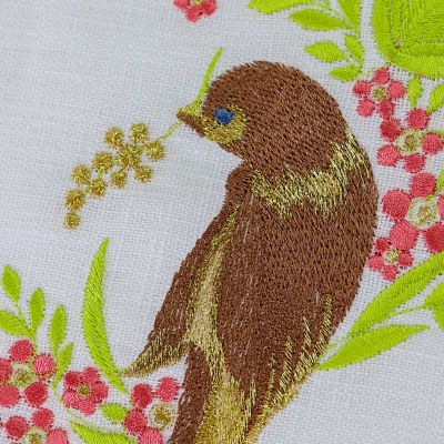 White table cloth with Easter embroidered bird in a tree