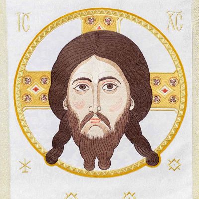 white analogion cover with medallion of Christ and tassels