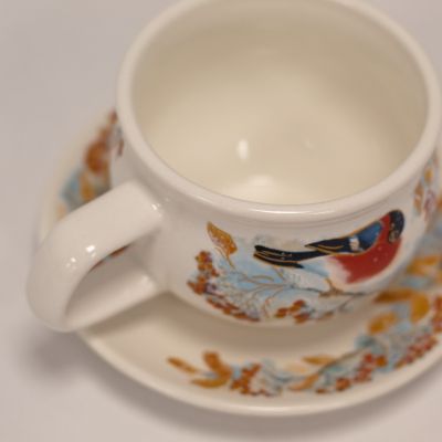 ceramic cup with bullfinch on the branch