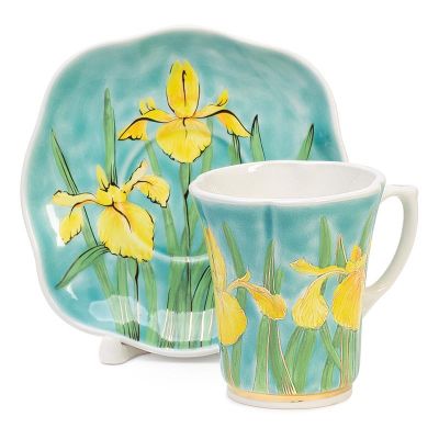 yellow irises in blue ceramic tea set and a saucer set