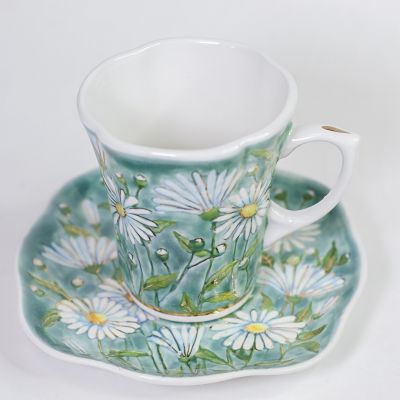 Cup and a saucer with painted white chamomiles